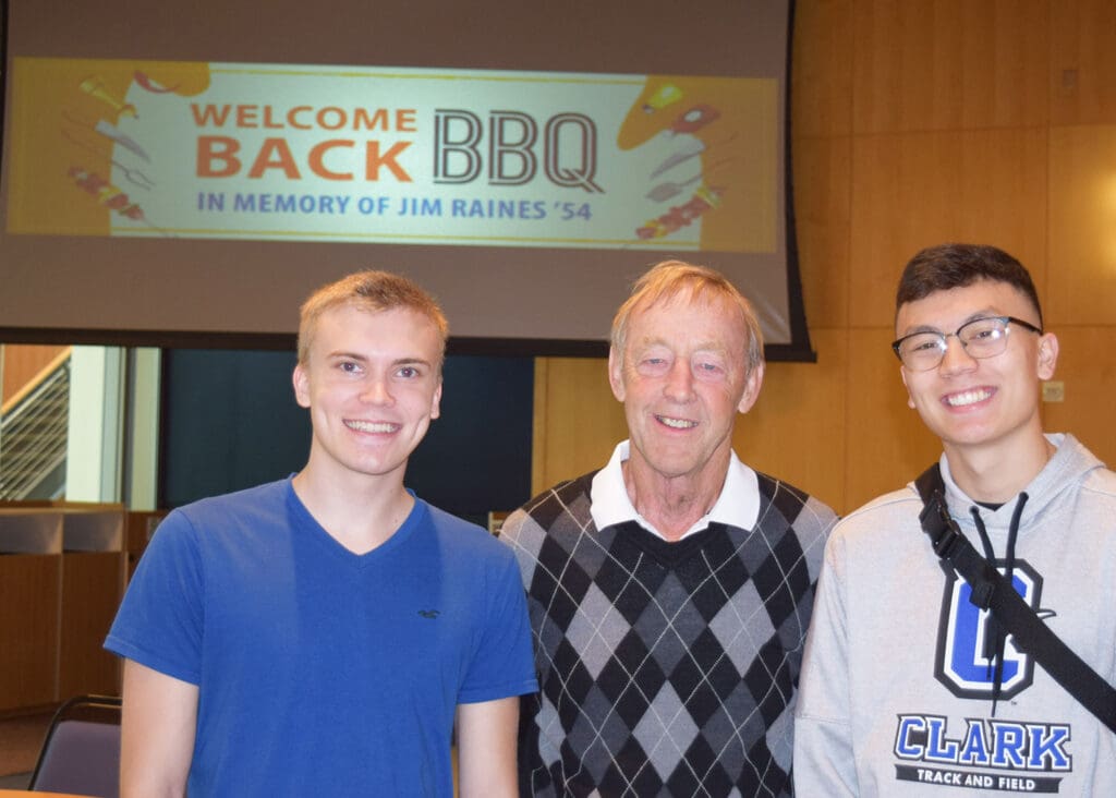 Denny Huston with two students at the 2019 Jim Raines BBQ